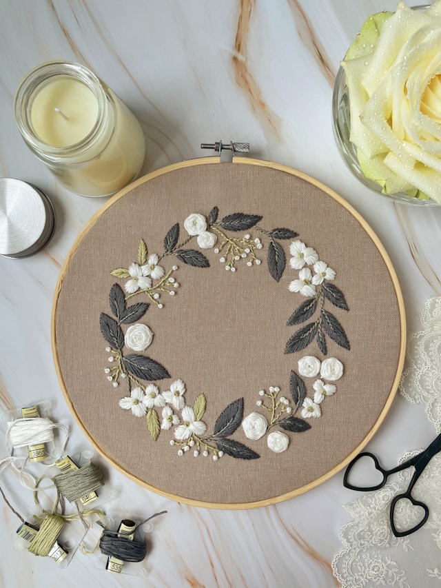 Detailed artisan embroidery on white linen - Ivy Embroidery Harrogate